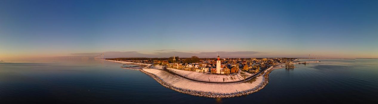 Panoramic view at the lighthouse of Urk Flevoland Netherlands, Urk during winter with white snow covered the beach. Winter in the Netherlands