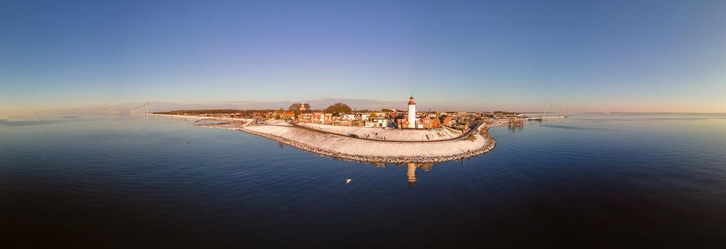 Panoramic view at the lighthouse of Urk Flevoland Netherlands, Urk during winter with white snow covered the beach. Winter in the Netherlands