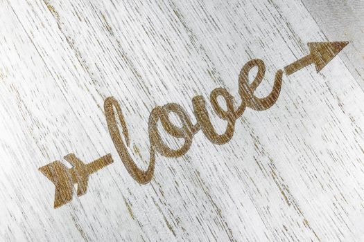 the inscription love on a wooden background top view. High quality photo