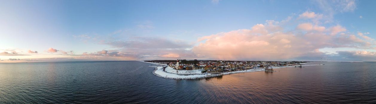 Panoramic view at the lighthouse of Urk Flevoland Netherlands, Urk during winter with white snow covered the beach. Winter in the Netherlands