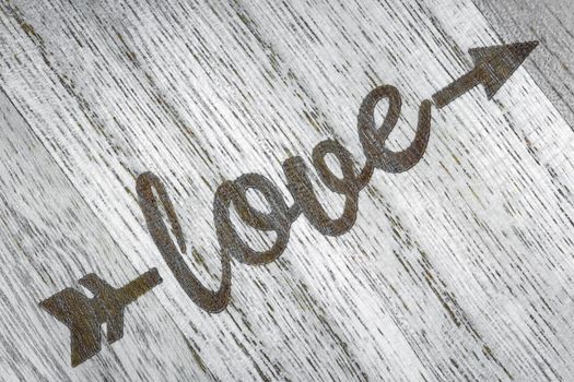 the inscription love on a wooden background top view. High quality photo