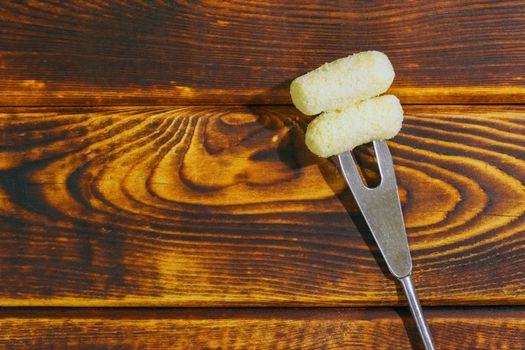 corn sticks on a fork on a wooden background. High quality photo