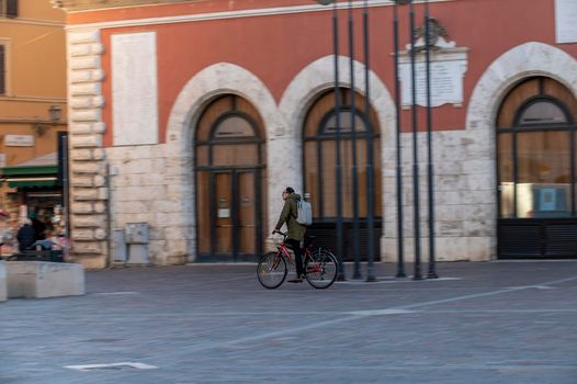 terni,italy february 15 2021:man riding a bicycle to the city center