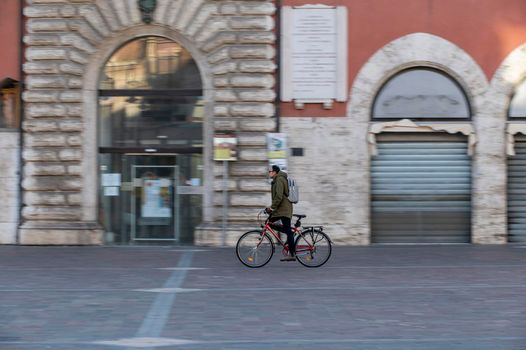 terni,italy february 15 2021:man riding a bicycle to the city center