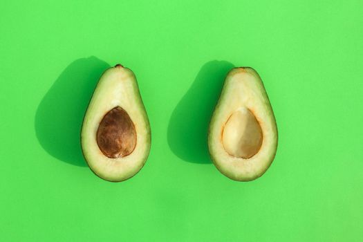 avocado on a colored background pattern top view