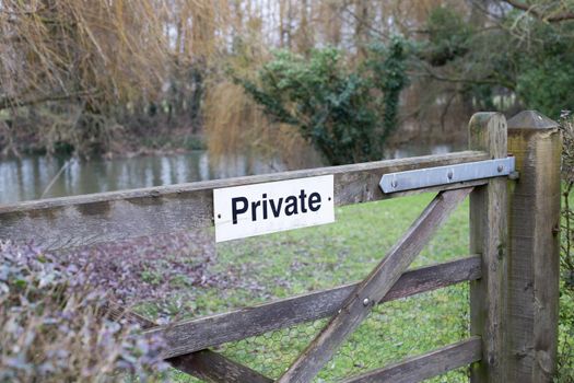 Private sign on farm wooden gate. Leading to spring meadow, field