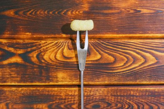 corn sticks on a fork on a wooden background. High quality photo