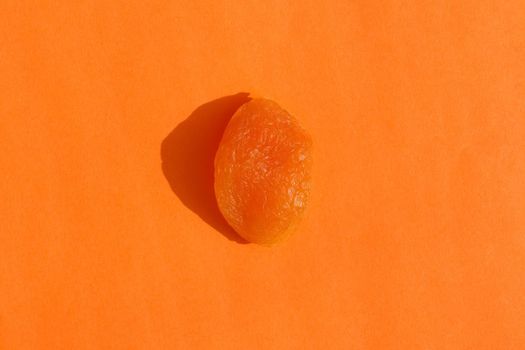 dried apricots with a hard shadow on a colored background pattern. High quality photo