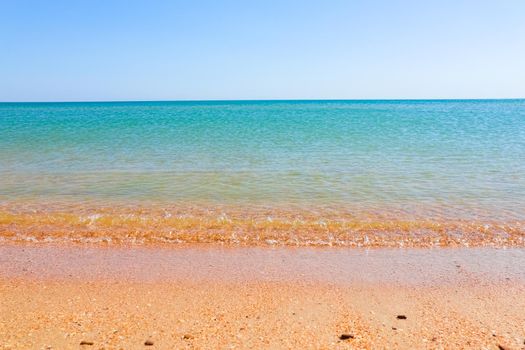 Soft Wave Of Blue Ocean On Sandy Beach. Background. Selective focus. High quality photo