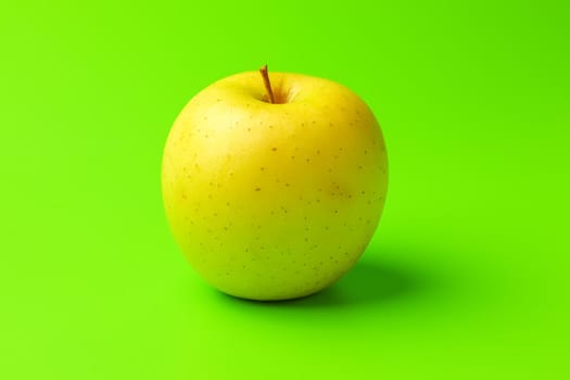 yellow Apple on a green background close-up.isolate. High quality photo