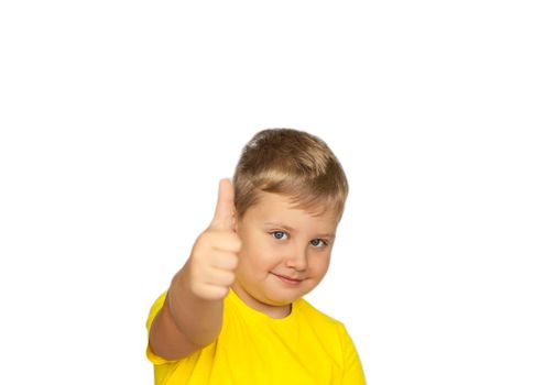 A boy in a yellow T-shirt on a white background points his fingers at a positive rating. Like. The concept of a banner with information. Space for the text. Concepts