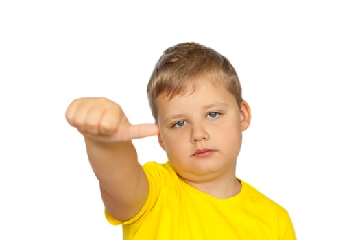 A boy in a yellow T-shirt on a white background points his fingers at a neutral rating. The concept of a banner with information. Space for the text. Concepts