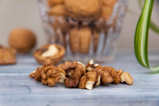 Walnuts on a painted background. Crystal bowl with nuts. Useful products. Walnuts.