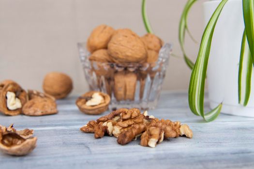 Walnuts on a painted background. Crystal bowl with nuts. Useful products. Walnuts.