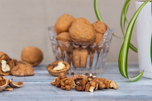 Walnuts on a painted background. Crystal bowl with nuts. Useful products. Walnuts.