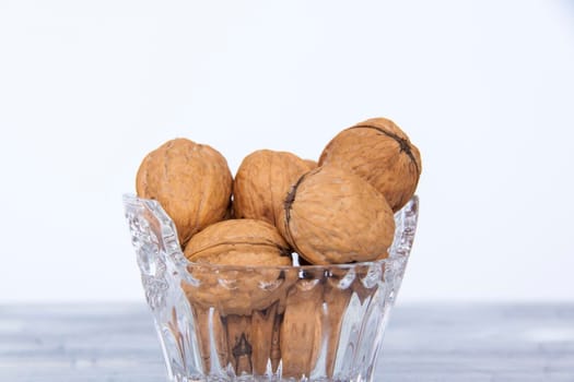 Walnuts in a shell in a crystal vase. Healthy nuts. Walnuts. 