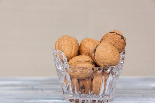 Walnuts in a shell in a crystal vase. Healthy nuts. Walnuts.