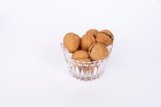 Walnuts in a shell on a white background. Healthy nuts. Walnuts. 