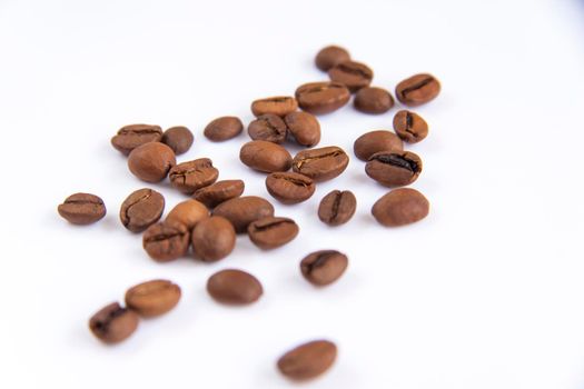 Coffee beans on a white background. Roasted coffee beans. Coffee.