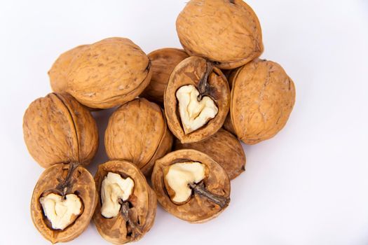 Walnuts in a shell on a white background. Healthy nuts. Walnuts