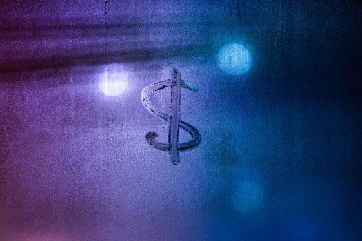 Dollar currency sign handwritten on fogged window. Dollar symbol on wet night window glass surface.