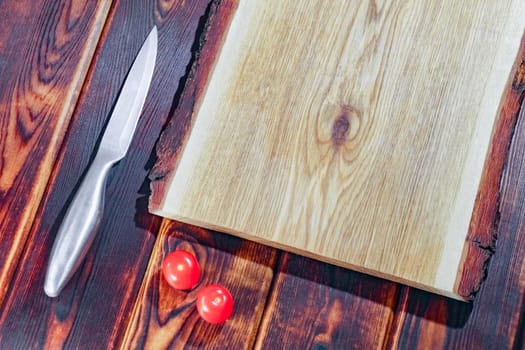 cutting Board with a knife and tomatoes top view. High quality photo