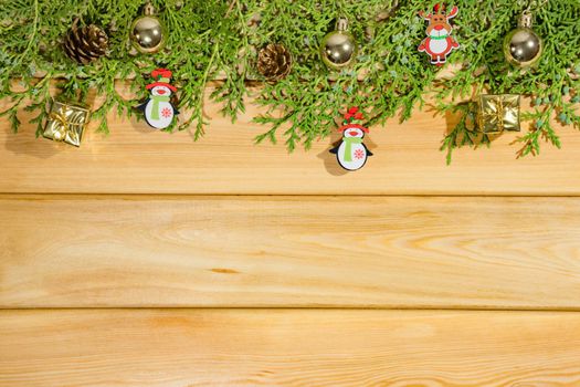 coniferous branches with Christmas toys on a wooden background top view. High quality photo