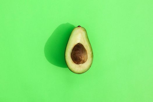 avocado on a colored background pattern top view