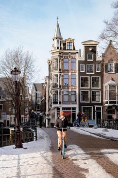 Amsterdam during winter with snowy streets. Amsterdam Netherlands February 2021