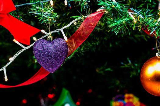 Christmas hanging decorations on fir tree. Decorated Christmas tree. Fir branch with Christmas baubles decorations.