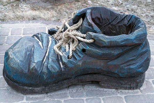 sculpture of a wooden shoe with laces close-up. High quality photo