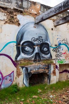 Villa Levidi, Pallini, Greece - February 14, 2021: Skull wall painting at an abandoned old villa at Pallini, Greece