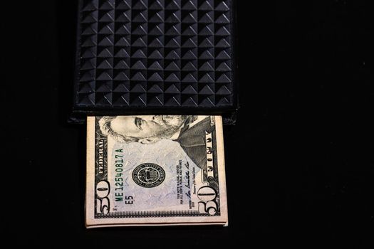 50 Dollars banknotes in a black wallet isolated.