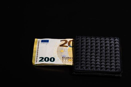 200 Euro banknotes in a black wallet isolated.
