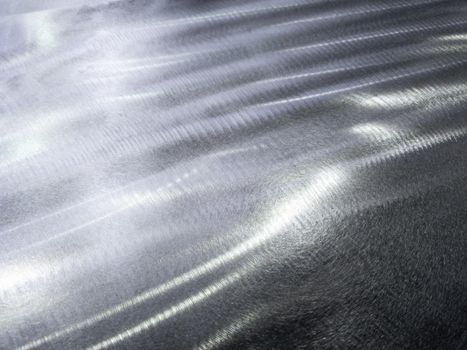 Close-up background of flat steel surface manually cleaned with a flap wheel angle grinder. Surface prepaired before painting as part of the repair work.