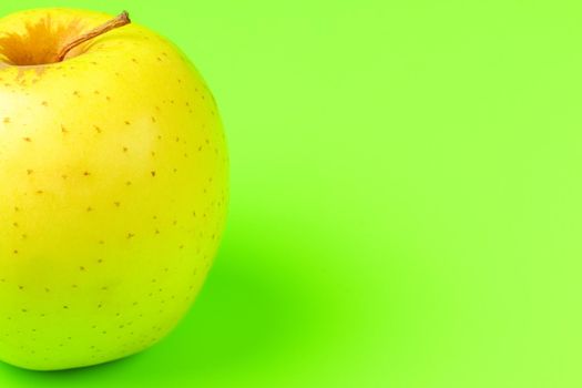 yellow Apple on a green background close-up.isolate. High quality photo