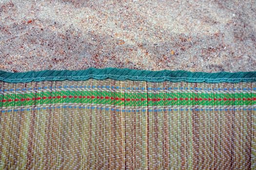 colored Mat on the beach sand as a background. High quality photo