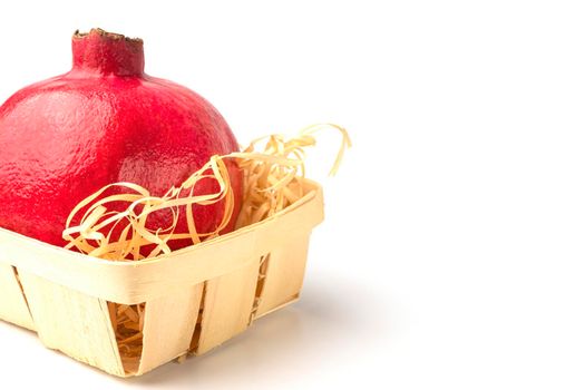 pomegranate in a basket on a white background close-up. isolate. High quality photo