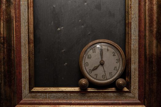 Vintage clock on black slate background and in marking