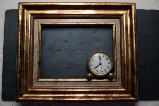 Vintage clock on black slate background and in marking