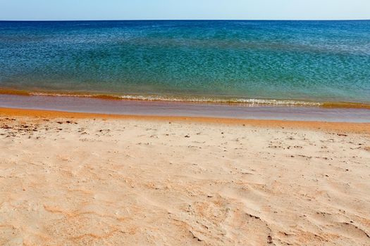 Soft Wave Of Blue Ocean On Sandy Beach. Background. Selective focus. High quality photo