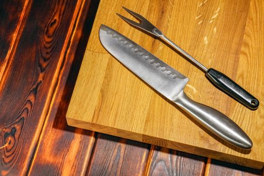 knife and fork on the cutting Board. High quality photo