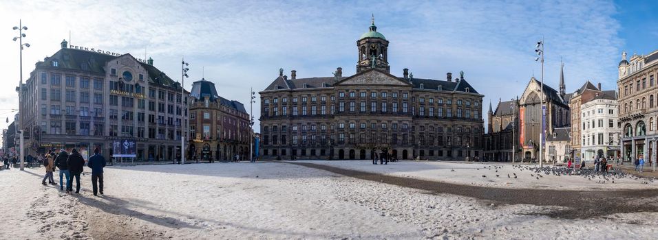 Amsterdam during winter with snowy streets, Amsterdam Dam square. Amsterdam Netherlands February 2021