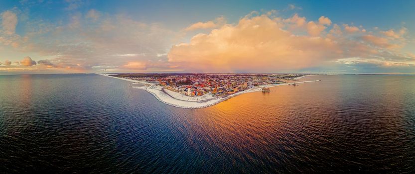 Panoramic view at the lighthouse of Urk Flevoland Netherlands, Urk during winter with white snow covered the beach. Winter in the Netherlands