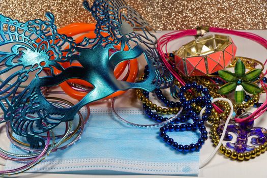 Mardi Gras carnival theme parade mask and jewelry with medical facemask on white