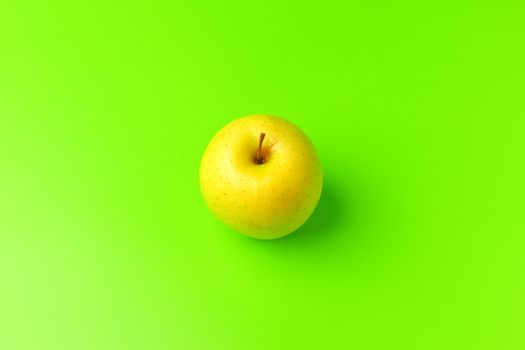 yellow Apple on a green background close-up.isolate. High quality photo