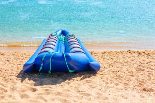 A boat sitting on top of a sandy beach next to the ocean. High quality photo