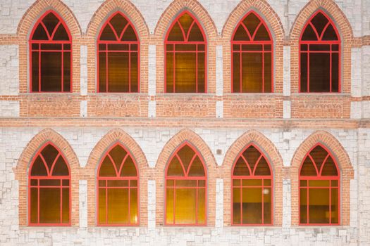 stone wall with red Windows as background. High quality photo