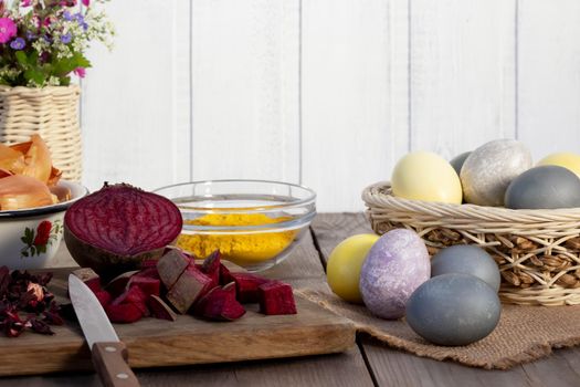 Process of coloring Easter eggs with various food natural dyes. Preparing for Easter