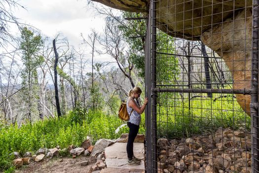 Grampians, Australia - 01 february 2015: you women is taking pictures of Ancient Aboriginal Art: hand prints, animal herds, spiral